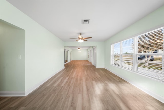 unfurnished living room with light wood-type flooring and ceiling fan