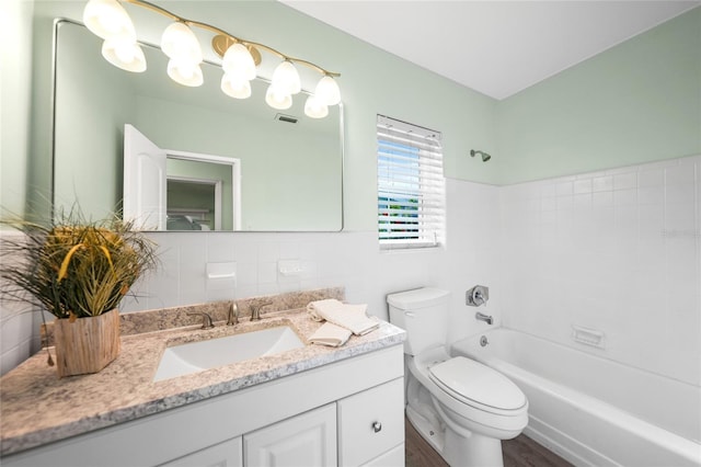 full bathroom featuring vanity, shower / washtub combination, wood-type flooring, tile walls, and toilet