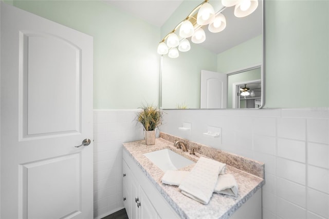 bathroom featuring vanity and tile walls