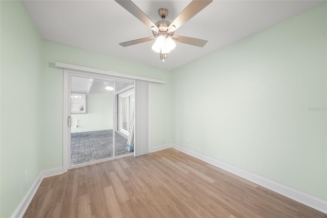 unfurnished bedroom with ceiling fan, a closet, and light wood-type flooring