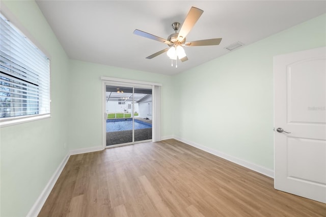 empty room featuring ceiling fan and light hardwood / wood-style flooring