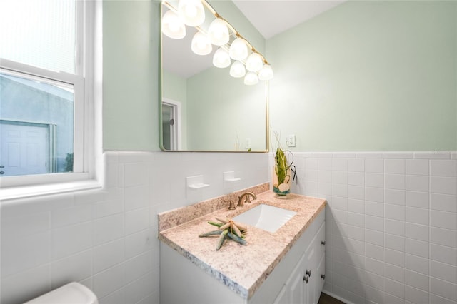 bathroom featuring vanity and tile walls