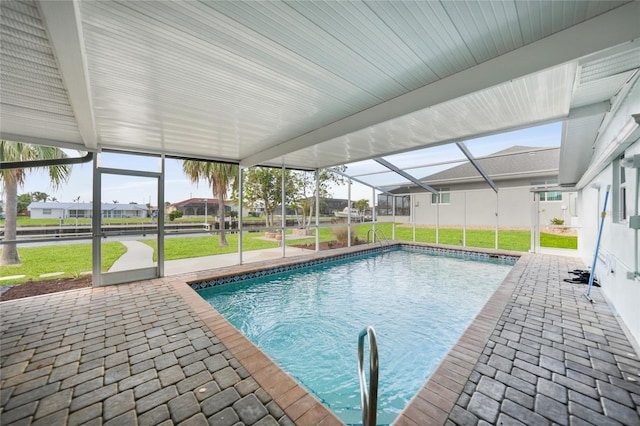 view of pool featuring a patio, glass enclosure, and a lawn