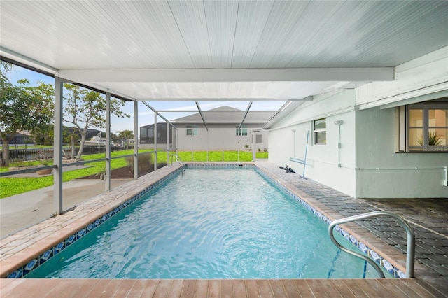 view of swimming pool with glass enclosure and a patio area