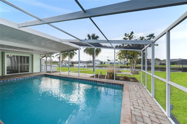 view of swimming pool featuring a lawn, glass enclosure, and a patio area