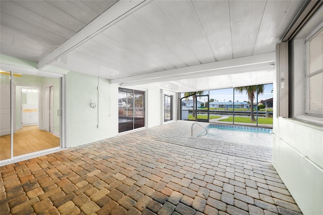 interior space featuring a swimming pool and beamed ceiling