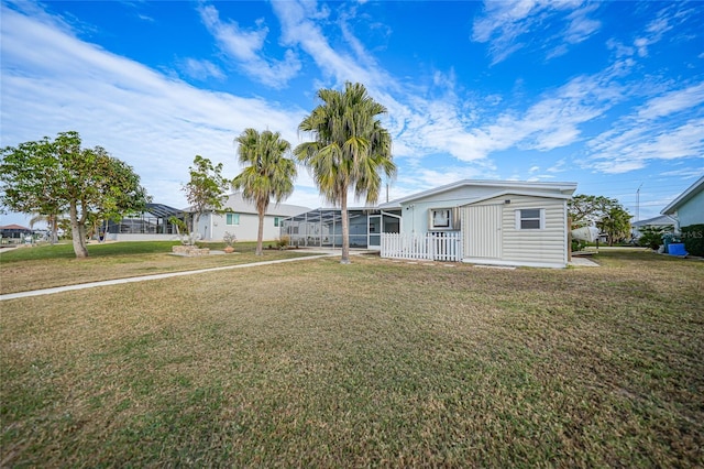 view of front of property featuring a lanai and a front lawn