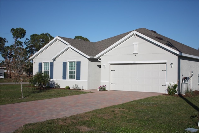 single story home with a garage and a front lawn