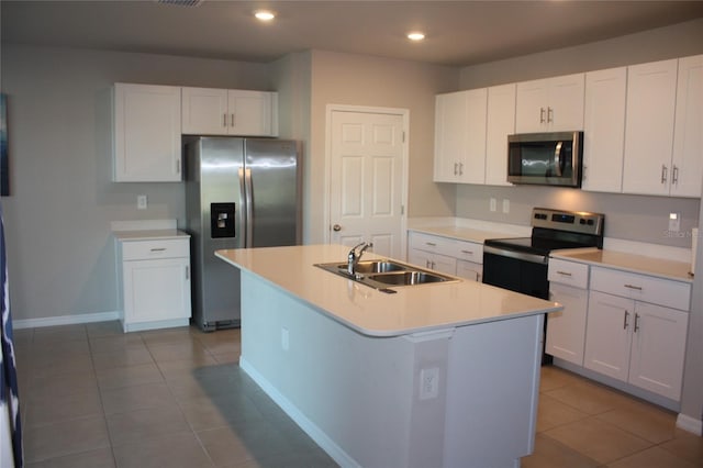 kitchen featuring a kitchen island with sink, sink, white cabinetry, and appliances with stainless steel finishes