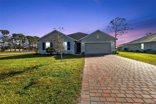 single story home with a yard and a garage