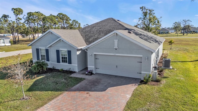 ranch-style home featuring central AC unit, a garage, and a front lawn