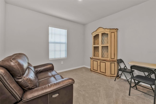 sitting room featuring light colored carpet