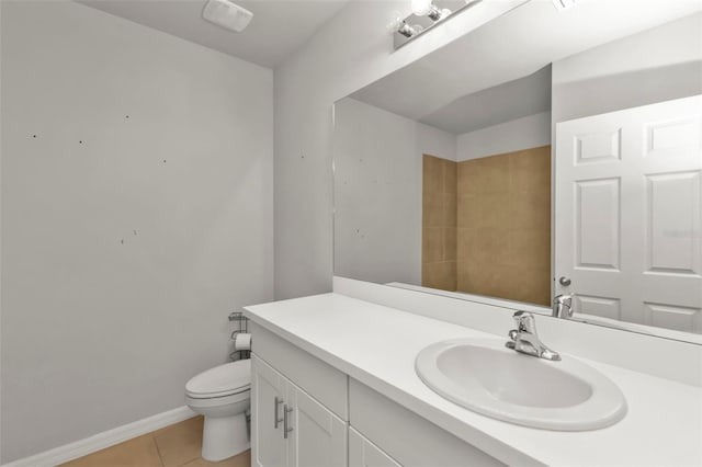 bathroom with vanity, tile patterned floors, and toilet