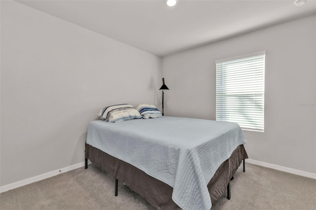 bedroom featuring light colored carpet