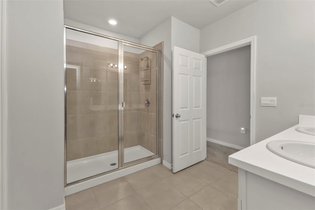 bathroom featuring vanity, a shower with door, and tile patterned floors