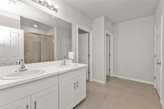 bathroom with a shower with door and vanity