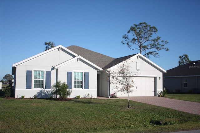 single story home featuring a garage, roof with shingles, decorative driveway, a front yard, and stucco siding