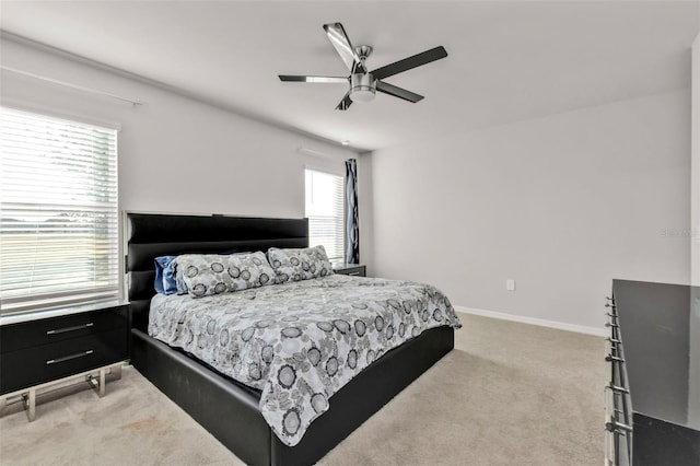 bedroom featuring ceiling fan and carpet