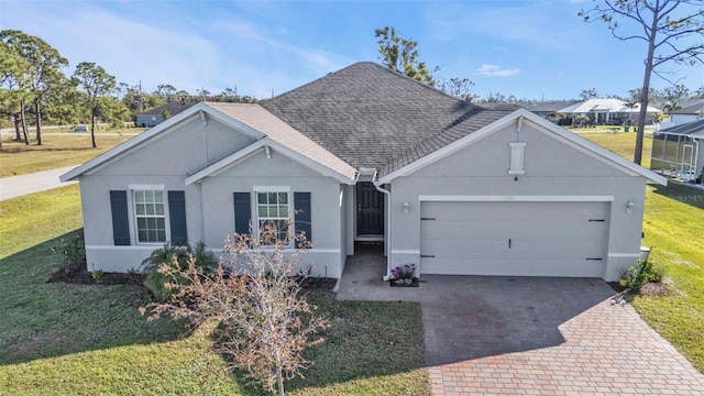 single story home featuring a garage and a front yard