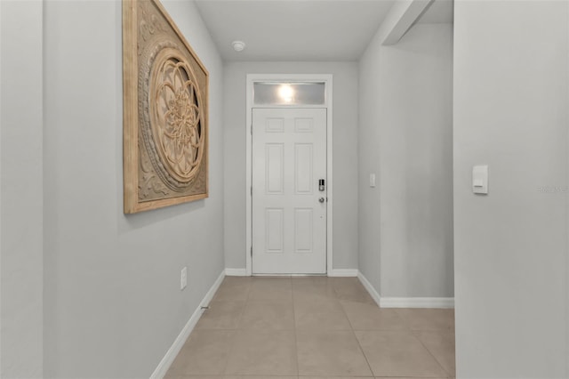 doorway to outside with light tile patterned floors