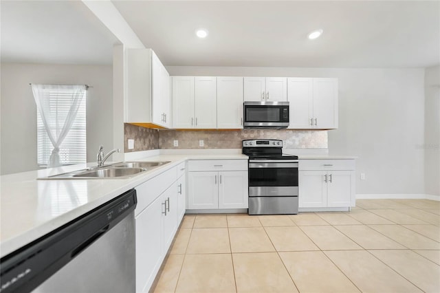 kitchen with tasteful backsplash, white cabinetry, sink, and stainless steel appliances