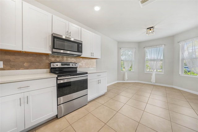 kitchen featuring backsplash, white cabinetry, and stainless steel appliances