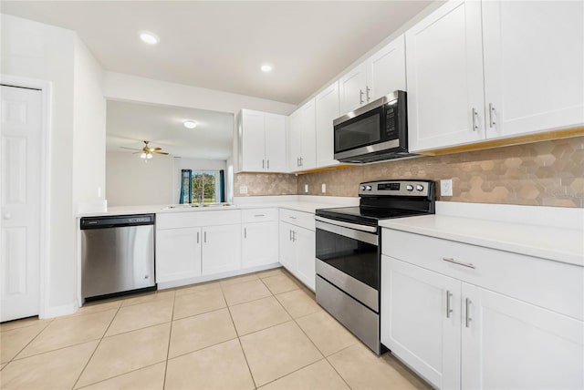 kitchen with light tile patterned flooring, white cabinetry, ceiling fan, and stainless steel appliances