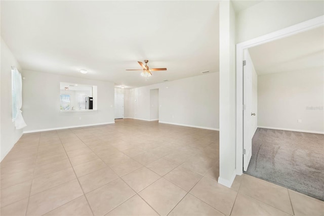 spare room with ceiling fan and light tile patterned floors