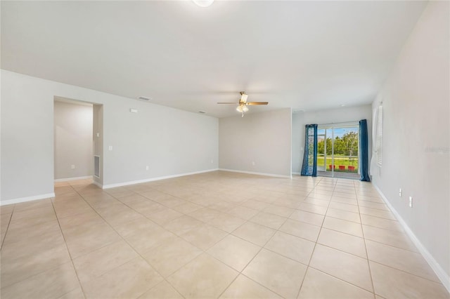 tiled spare room featuring ceiling fan