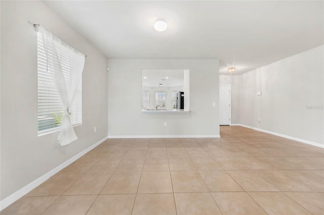 unfurnished living room featuring light tile patterned floors