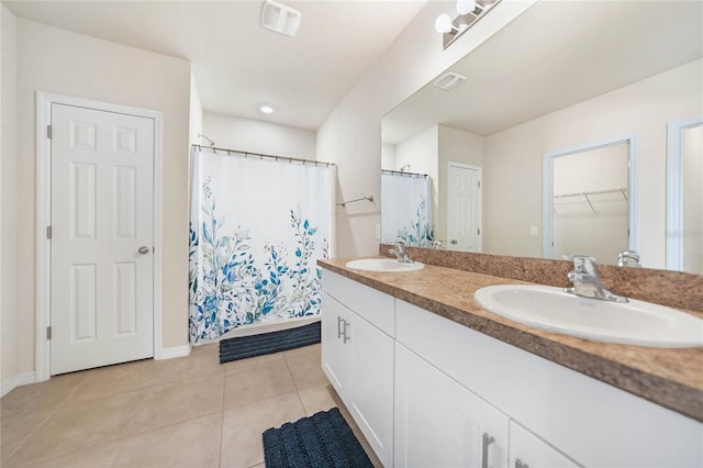 bathroom featuring curtained shower, tile patterned flooring, and vanity