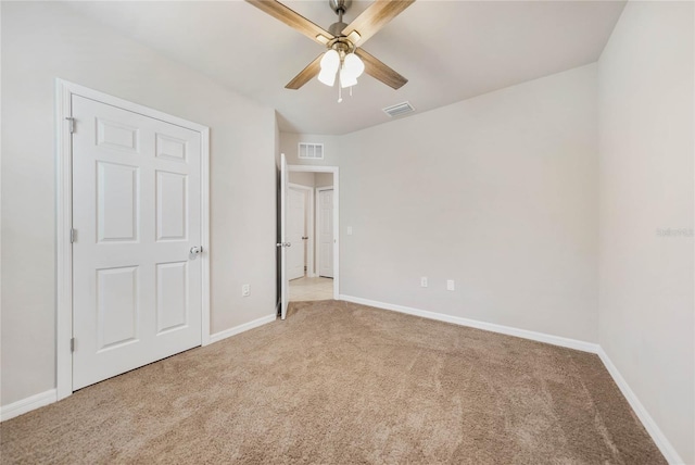 unfurnished bedroom with light carpet and ceiling fan