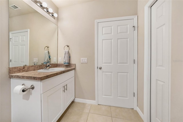 bathroom featuring tile patterned flooring and vanity