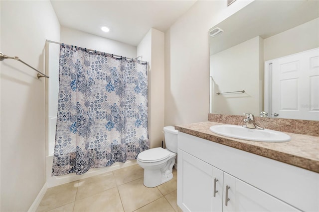 bathroom featuring tile patterned flooring, vanity, and toilet