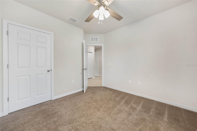 unfurnished bedroom with light carpet and ceiling fan