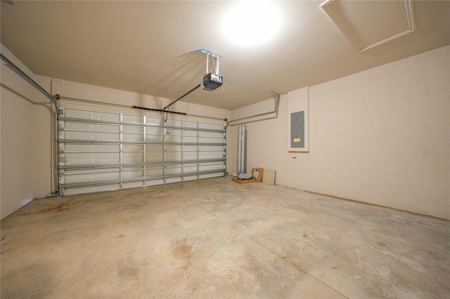 garage with a garage door opener and electric panel