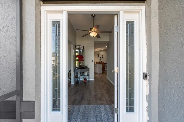 entrance to property with ceiling fan