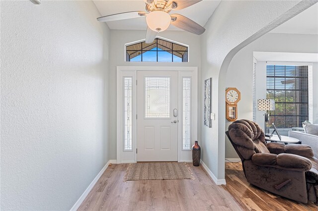 entryway featuring light hardwood / wood-style floors, ceiling fan, and lofted ceiling