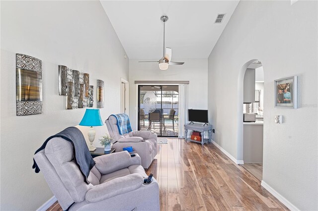 living room with ceiling fan and hardwood / wood-style floors