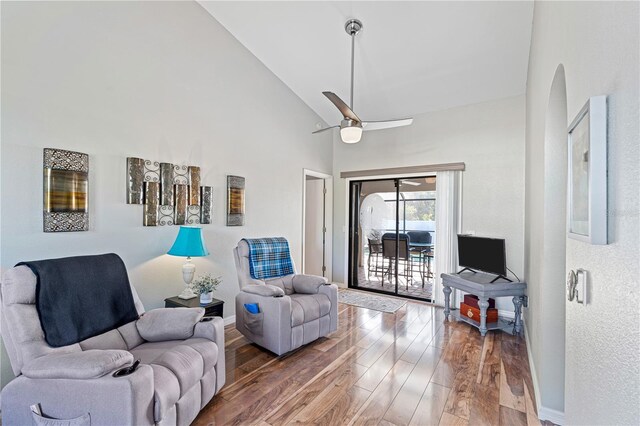 living room featuring hardwood / wood-style flooring, high vaulted ceiling, and ceiling fan