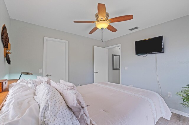 bedroom with ceiling fan and light hardwood / wood-style flooring