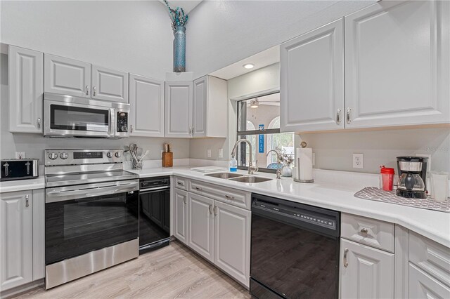 kitchen featuring white cabinets, light hardwood / wood-style floors, sink, and stainless steel appliances