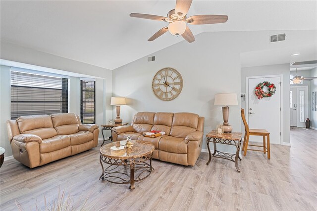 living room with lofted ceiling, ceiling fan, and light wood-type flooring