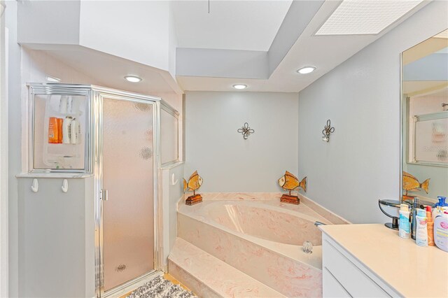 bathroom featuring vanity and separate shower and tub