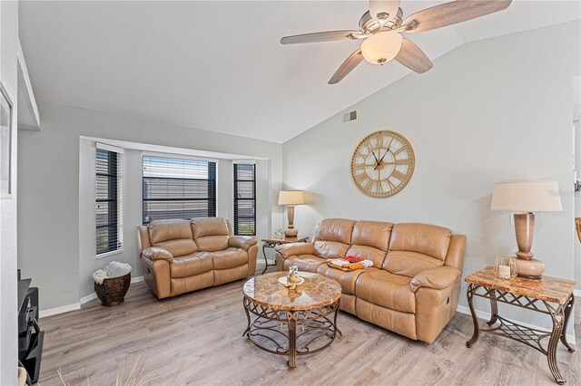 living room with ceiling fan, light hardwood / wood-style floors, and lofted ceiling