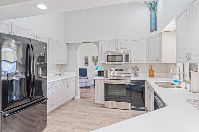 kitchen with white cabinets, stainless steel appliances, and sink