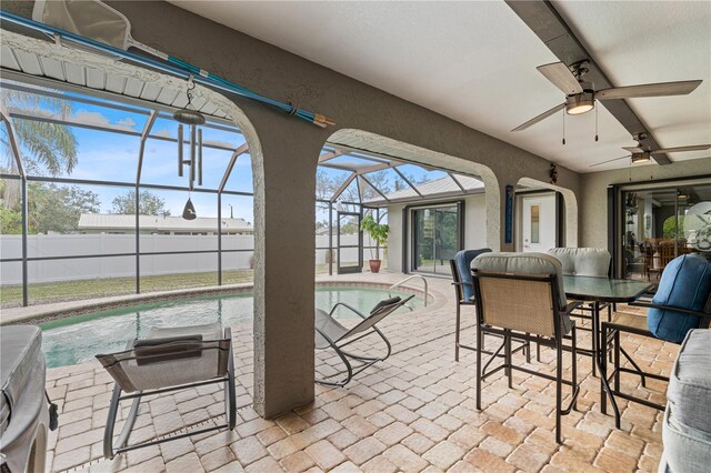 sunroom / solarium featuring a wealth of natural light and ceiling fan