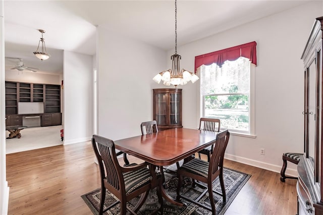 dining room featuring hardwood / wood-style floors, plenty of natural light, and ceiling fan with notable chandelier