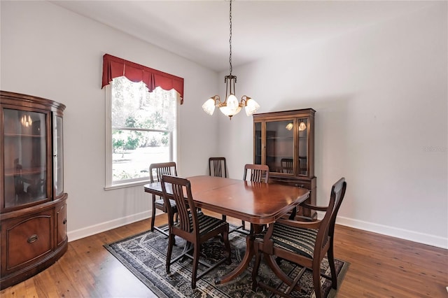 dining room featuring dark hardwood / wood-style floors and a notable chandelier