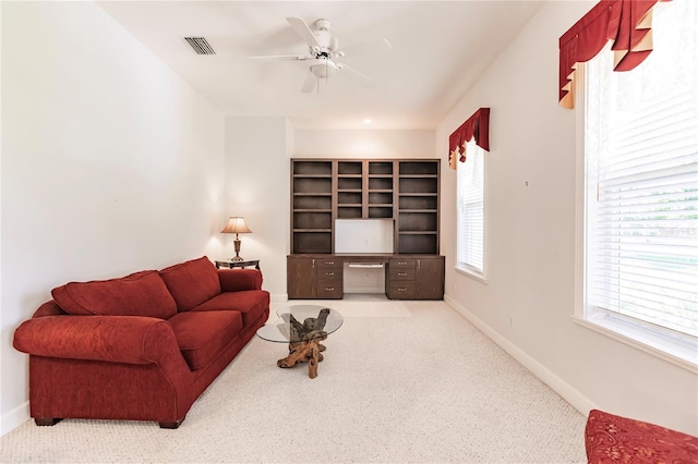 carpeted living room featuring ceiling fan